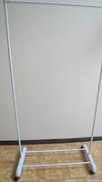 Full view of the white freestanding clothes rack