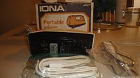 Underside of IONA mixer with original box, power cord bagged