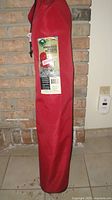 Chair in red carry bag standing upright