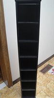 Full front view of black IKEA CD tower showing overall height and five shelf spaces