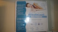 Front of sealed HealthGuard mattress protector box showing product information and size