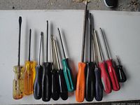 All eleven screwdrivers laid out to show handle colors, tip types and overall condition