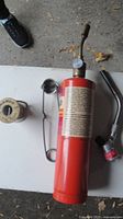 Full view of propane cylinder with attached torch, separate torch head, solder spool and wire stand