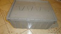Grey plastic storage container closed showing lid style and exterior condition