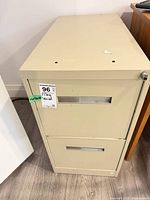 Front and top view of beige 2-drawer filing cabinet showing drawer fronts and lock