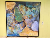 Full view of framed abstract mixed media painting on wall