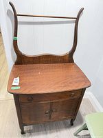 Front view of washstand showing drawer, cabinet doors, backsplash