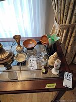 Group shot of all eight small decorative items on glass table
