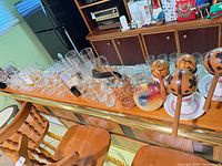 Wide view of bar top showing assorted glassware, maracas, candle, coaster holder