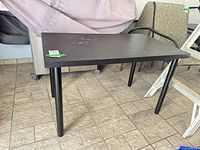 Full view of black rectangular table on tiled floor