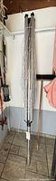 Full view of folded rotary clothesline on pole