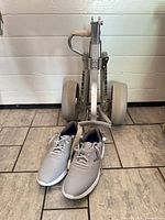 Gray Callaway shoes placed in front of folded Par-Rite push cart showing overall lot