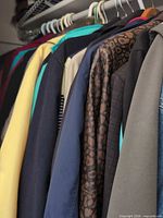 Row of assorted coats and jackets on hangers