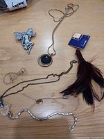 All seven jewellery pieces laid out on table