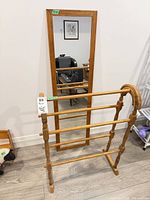 Wall mirror and blanket rack together