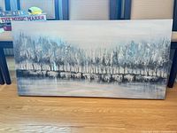 Front view of acrylic landscape painting showing tree line scene