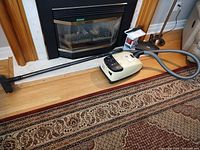 Full view of Miele S518 canister vacuum with hose, wand and power nozzle on floor