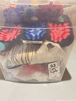 clear bin with yarn skeins and afghan on top