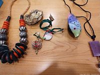 Overview of all seven jewelry pieces on tabletop
