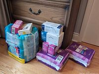 Group shot of all sealed incontinence supplies, mask boxes and pads