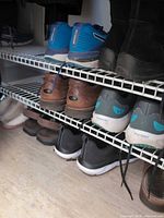 Multiple pairs of shoes on wire rack shelves