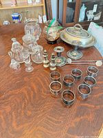 overview of all silverplate, glass and Mexican silver items on table