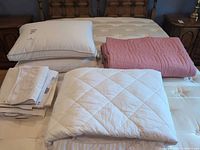 Overall view of bedding items laid out on mattress