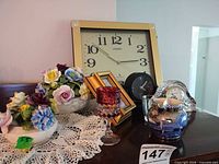 Group shot of all items including Citizen wall clock, crystal clock, Radnor posy bowl, Wedgwood cup, red goblet