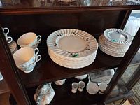 Cabinet view showing stacks of plates and teacups
