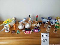 Group overview of all miniature figurines, pitchers, Red Rose novelties and salt & pepper shakers on shelf