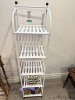 Full view of white 5-shelf unit with contents