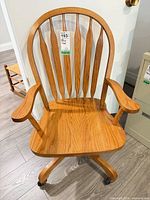 Front view of solid oak spindle-back swivel office chair