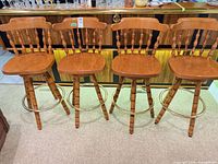 Four matching Windsor-style bar stools front view