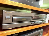 Front view of Technics SL-PG100 showing power switch, disc drawer, MASH logo