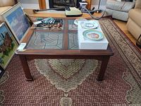 Square cherry wood coffee table with four glass panels, view from front