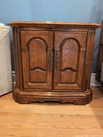 front view of medium oak side cabinet closed