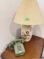 Lamp and telephone on table, showing overall lot