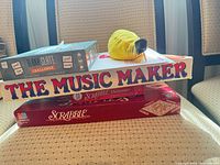Stack showing Music Maker box, Scrabble box, Scrabble Dictionary, Blank Slate box, Bananagrams pouch