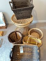 Group shot of wicker pedestal table with multiple baskets
