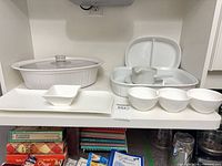 Full group shot of casserole, baking dish, tray, dip bowl and three bowls