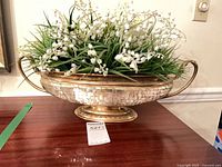 Side view showing vase shape, mosaic surface, handles and faux flowers