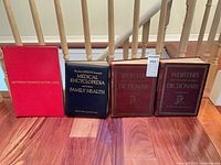 Group shot of all four hardcover books standing upright