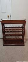 Front view showing entire wooden wine rack with four shelves and tray in place