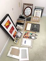 Full group of assorted frames on floor and in plastic bin
