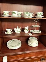 Full view of china pieces on cabinet shelves