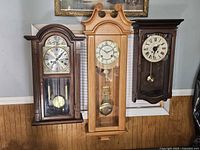 All three wall clocks displayed together