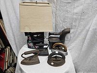 group view showing all six irons including lamp, chimney iron and three sad irons