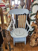 Front view of light blue wooden commode chair with lid in place