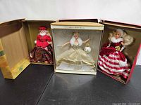 Three boxed Barbie dolls displayed: Jewel Princess 1996, Celebration 2000, Peppermint Princess 1994