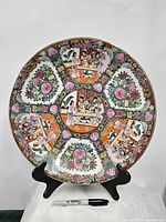 Full view of 14" famille rose charger on stand